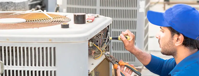 HVAC technician servicing home cooling equipment
