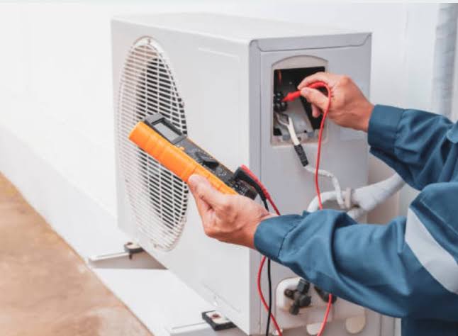 HVAC technician completing residential air conditioner maintenance