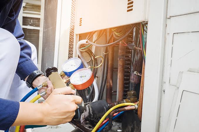 HVAC technician testing climate equipment components