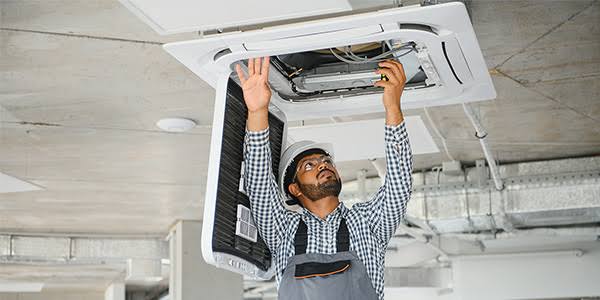 Technician performing residential HVAC repair